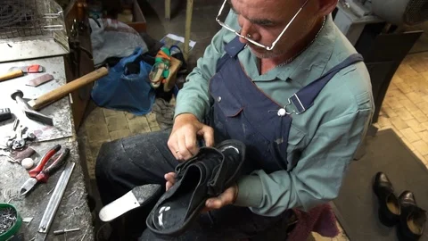 A shoemaker cleans in the workplace at the end of the day Stock Footage 77881105