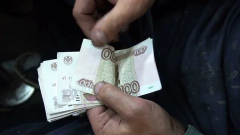 Shoemaker counts the money earned at the end of the working day Stock Footage