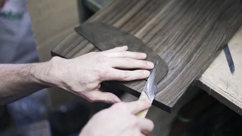 Shoemaker cutting leather with a knife Stock-Footage 75938984