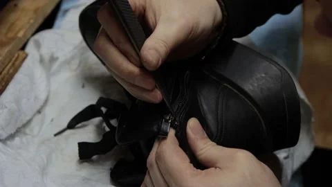 Shoemaker fixing shoe in his workshop Stock Footage 130858266