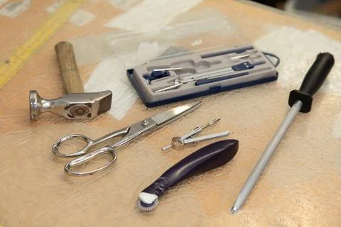 Shoemaker hammer tool, scissors and a measure tape Stock Photos