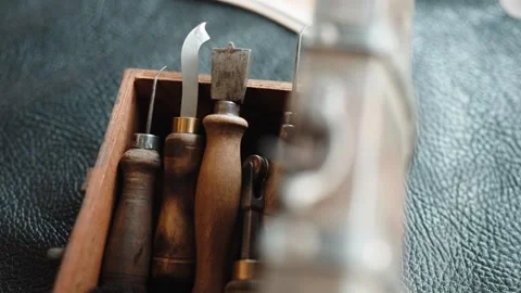 Shoemaker Hand Tools with Wooden Handles in Wooden Box on Leather Hide Stock Footage 343975812