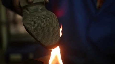 Shoemaker making shoes. Working with fire at cobbler workshop. Slow motion. Stock-Footage 71256153