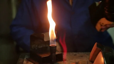 Shoemaker making shoes. Working with fire at cobbler workshop. Slow motion. Video stock 71257079