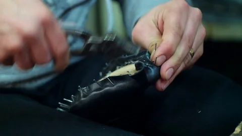 Shoemaker making shoes. Working with nails at cobbler workshop. Close up view. Video stock 71251832