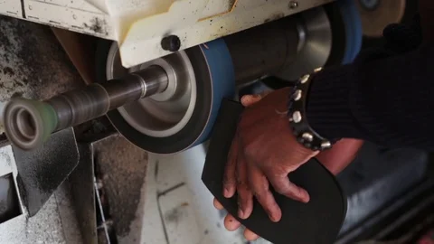Shoemaker performs shoes in the studio craft grinder machine. Stock Footage 104984718