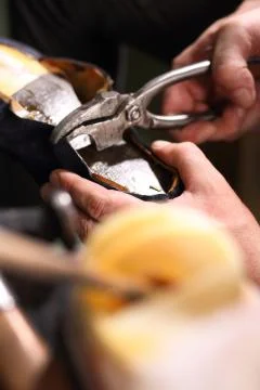 Shoemaker performs shoes in the studio craft Stock Photos