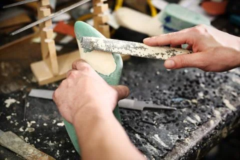 Shoemaker performs shoes in the studio craft Stock Photos