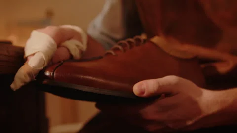 Shoemaker polishes shoes in workshop Stock Footage 241168122
