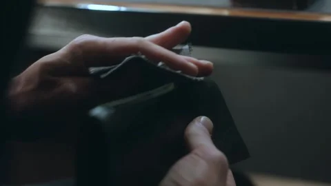 Shoemaker polishing leather wallet edge with cloth Video stock 296747299