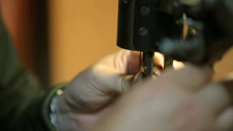 Shoemaker preparing sewing-machine. Close shot. Видео 125460588