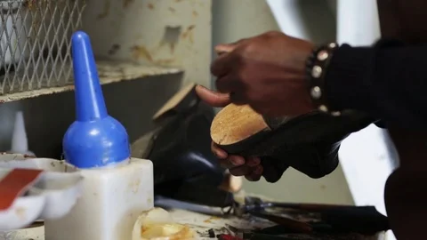 Shoemaker puts the glue on the sole of a shoe Stock Footage 104984490