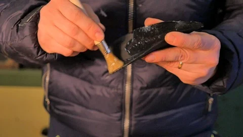 Shoemaker puts the glue on the sole of a woman's shoe - Slow Motion Stock Footage 85525362