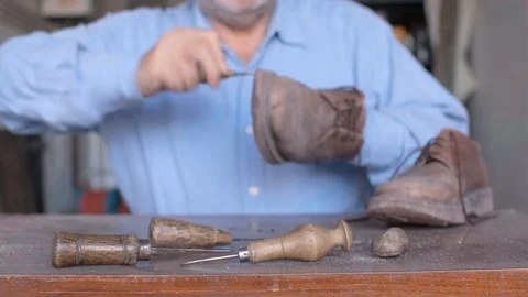 Shoemaker repairing a shoe Video stock 117583162