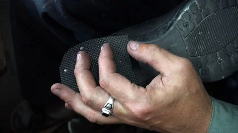 Shoemaker repairing a shoe in workshop 4k nail the heel cap to the heel Stock Footage 77877161