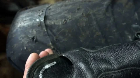 Shoemaker repairing a shoe in workshop 4k,sizing shoes Stock Footage 77870282