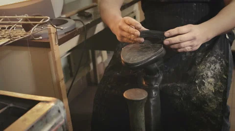 Shoemaker repairs heel Stock Footage 61790480