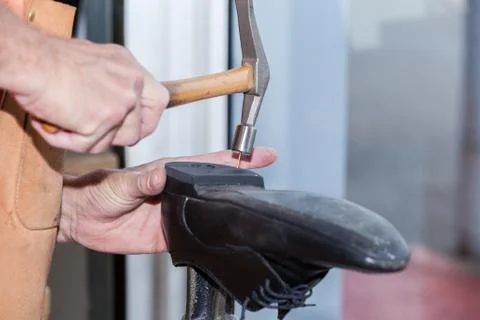 The shoemaker repairs a shoe Stock Photos
