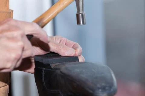 The shoemaker repairs a shoe Stock Photos
