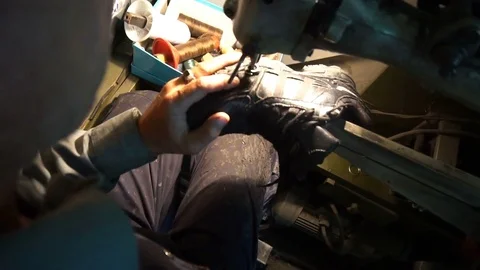Shoemaker sews the shoes on the machine Stock-Footage 77920230