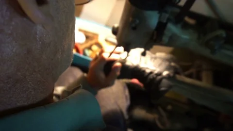 Shoemaker sews the shoes on the machine Video stock 77920362