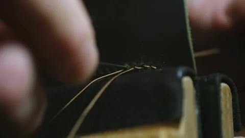 Shoemaker stitching leather with needle and thread Stock-Footage 296551838