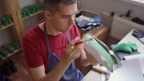 Shoemaker using plastic last and glue to make shoes Stock Footage 142549657