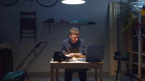 Shoemaker watches lessons on the Internet. Work from home Video stock 127837879