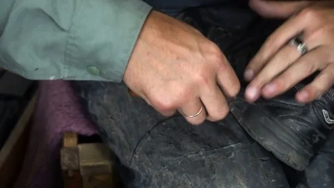 The shoemaker at work.The process of repairing shoes in workshop Stockbeeldmateriaal 77919661