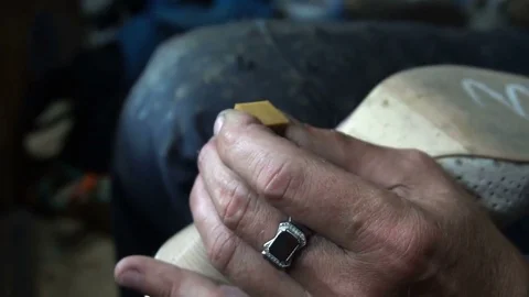 The shoemaker at work.The process of repairing shoes in workshop Stock Footage 77921848