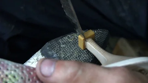 The shoemaker at work.The process of repairing shoes in workshop Stock Footage