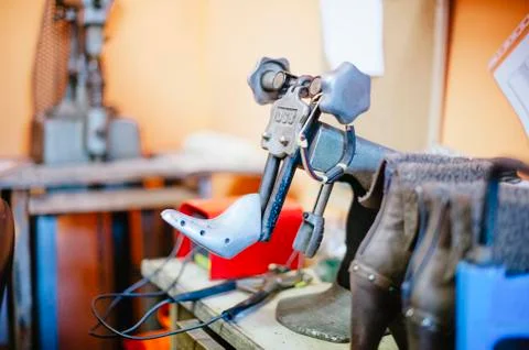 Shoemaker workshop machine to reshoke shoes Stock Photos