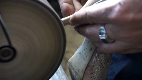 The shoemaker's sharpening metal taps on the machine Stock Footage 77917524