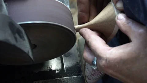 The shoemaker's sharpening metal taps on the machine Stock Footage 77917705