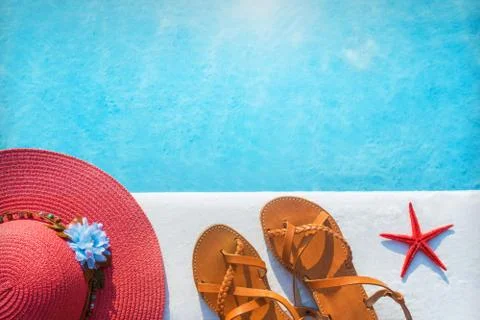 Shoes and hat by the pool Stock Photos