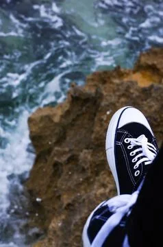 Shoes at the background of ocean Stock Photos