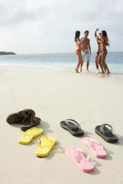 Shoes on beach with people in background Stock Photos