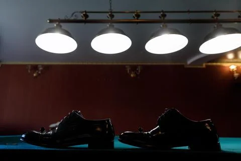Shoes on the billiard table Stock Photos