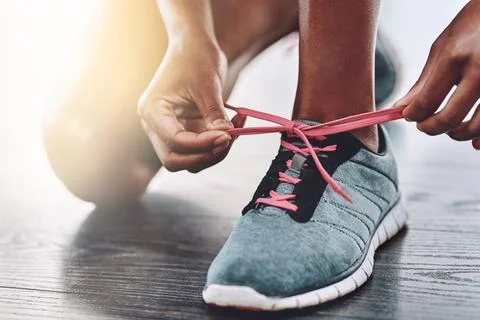 Shoes, closeup and person tying laces to start exercise, workout or wellness Stock Photos