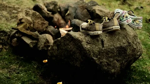 Shoes drying by campfire Stock Footage 200978115