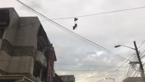Shoes hanging on wire Stock Footage 84042259