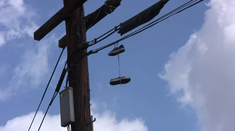 Shoes Hanging On Wire medium Stock Footage 1067679