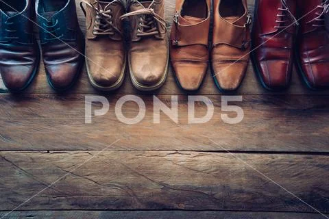Shoes for men various styles on a wooden floor - lifestyles. Stock Photos