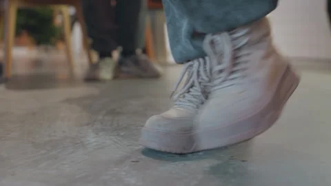 Shoes move purposefully. Walking shoes approach cafe counter deliberately Stock Footage 335765673