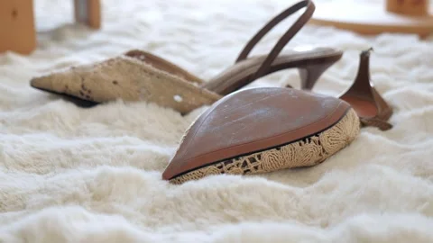 Shoes placed on soft white carpet in a room Stock Footage 343224974