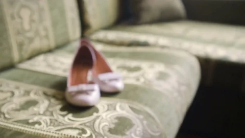 Shoes rose of the bride on the couch Stock Footage 82954787