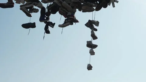 Shoes on String Dangling - Slow Motion Stock Footage 307932376