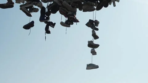 Shoes on a String Over A Street - Regular Speed Stock Footage 307932363