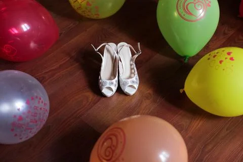 Shoes white of the bride on the floor Stock Photos