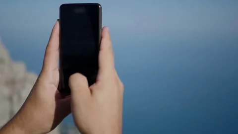 Shoot a blue sky and sea on a phone, close-up. HD, 1920x1080. slow motion Stock Footage 80482104